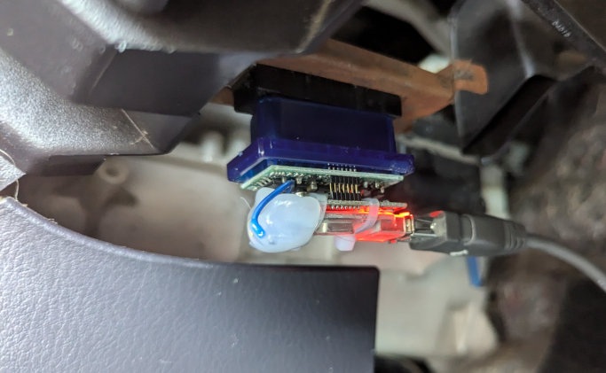 An image of the OBD-II adapter plugged into the car