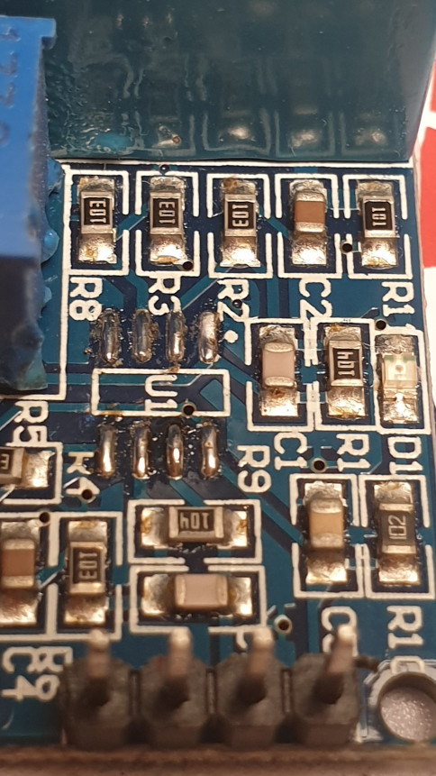 Photo showing the ZMPT101B voltage sensor module with the op-amp removed (showing bare pads)